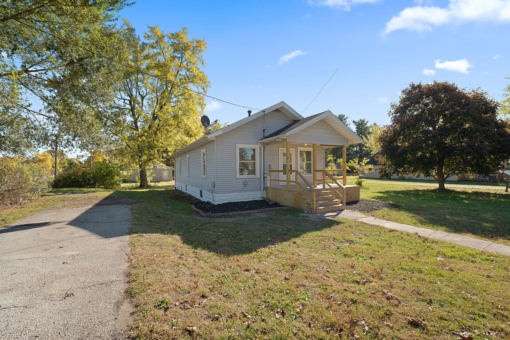 813 Carnation Street Southeast De Motte, IN 46310 - Photo 22 of 26 a view of a yard with plants and a large tree