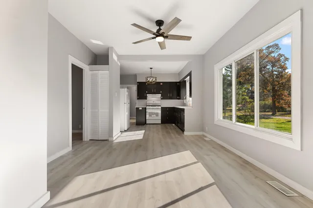 a open kitchen with stainless steel appliances granite countertop a refrigerator and a sink