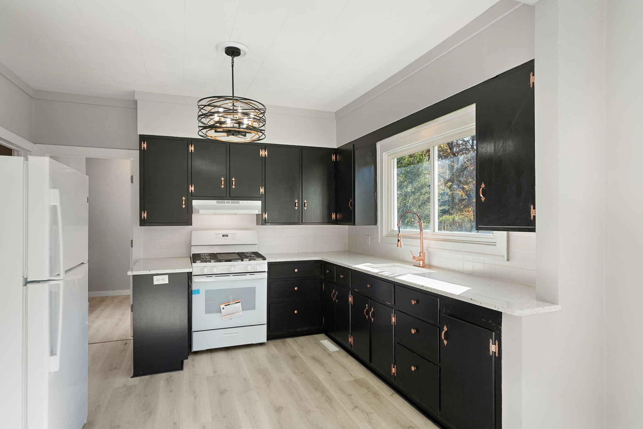 813 Carnation Street Southeast De Motte, IN 46310 - Photo 10 of 26 a kitchen with stainless steel appliances granite countertop a sink stove and refrigerator