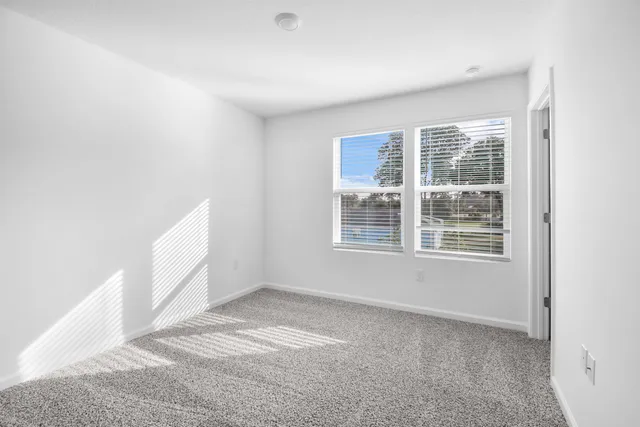 a view of a livingroom with an empty space and a window