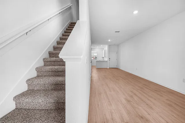 a view of entryway and hall with wooden floor