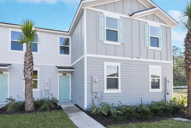 a view of a house with a yard and plants