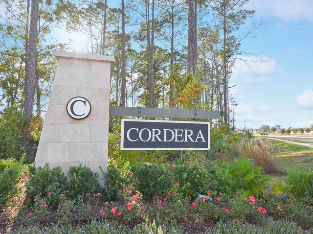 a sign that is sitting in front of flowers