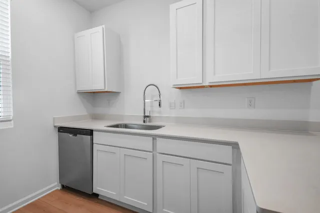 a kitchen with white cabinets and a sink