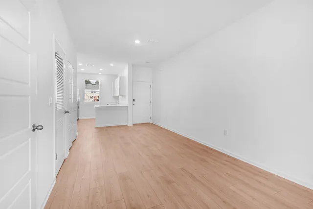 a view of a kitchen with a refrigerator and a cabinets