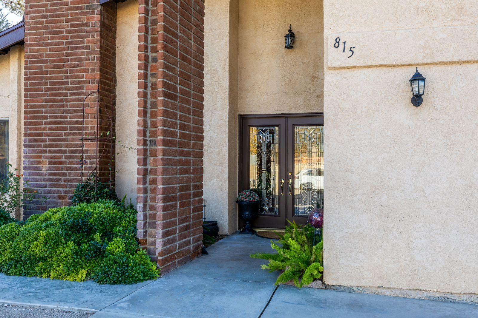 815 Hurschell Avenue Ridgecrest, CA 93555 - Photo 3 of 43 a potted plant sitting in front of a door
