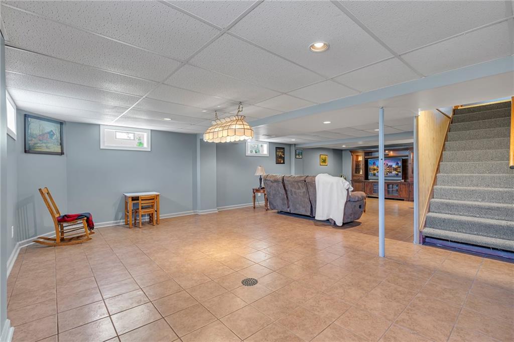 383 Ridgemont Drive Midland, PA 15059 - Photo 21 of 44 a living room with furniture gym equipment and a ceiling fan