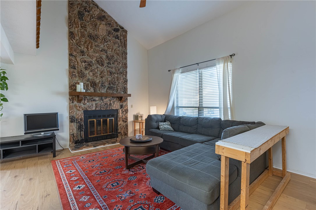 5399 Country Ridge Drive Mason, OH 45040 - Photo 4 of 29 This inviting living room features a striking stone fireplace, vaulted ceilings, and warm wood flooring.