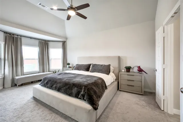 a spacious bedroom with a bed and window