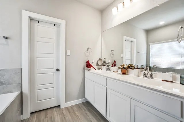 a bathroom with a double vanity sink and mirror