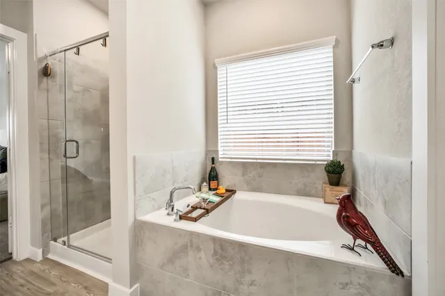 a bath tub sitting next to a shower