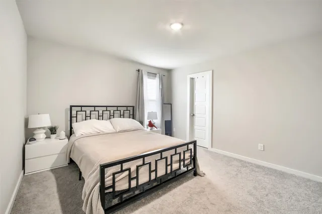 a bedroom with a bed and a night stand