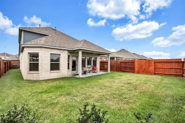 an aerial view of a house with a yard