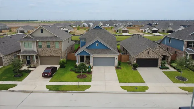 an aerial view of residential houses with outdoor space