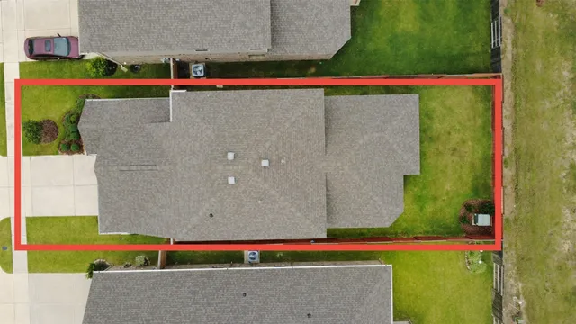 a aerial view of a house with a yard and potted plants