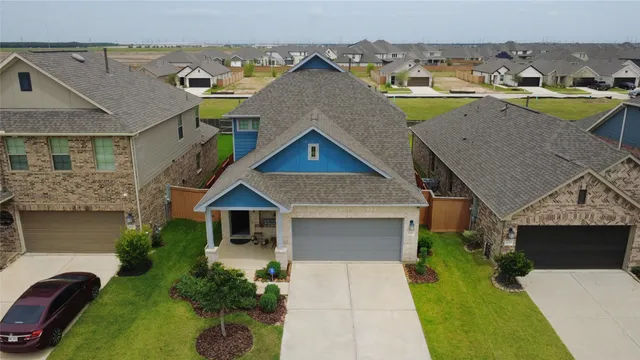 a view of a big house with a big yard and a large tree