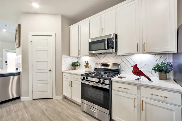 a kitchen with a sink microwave and cabinets