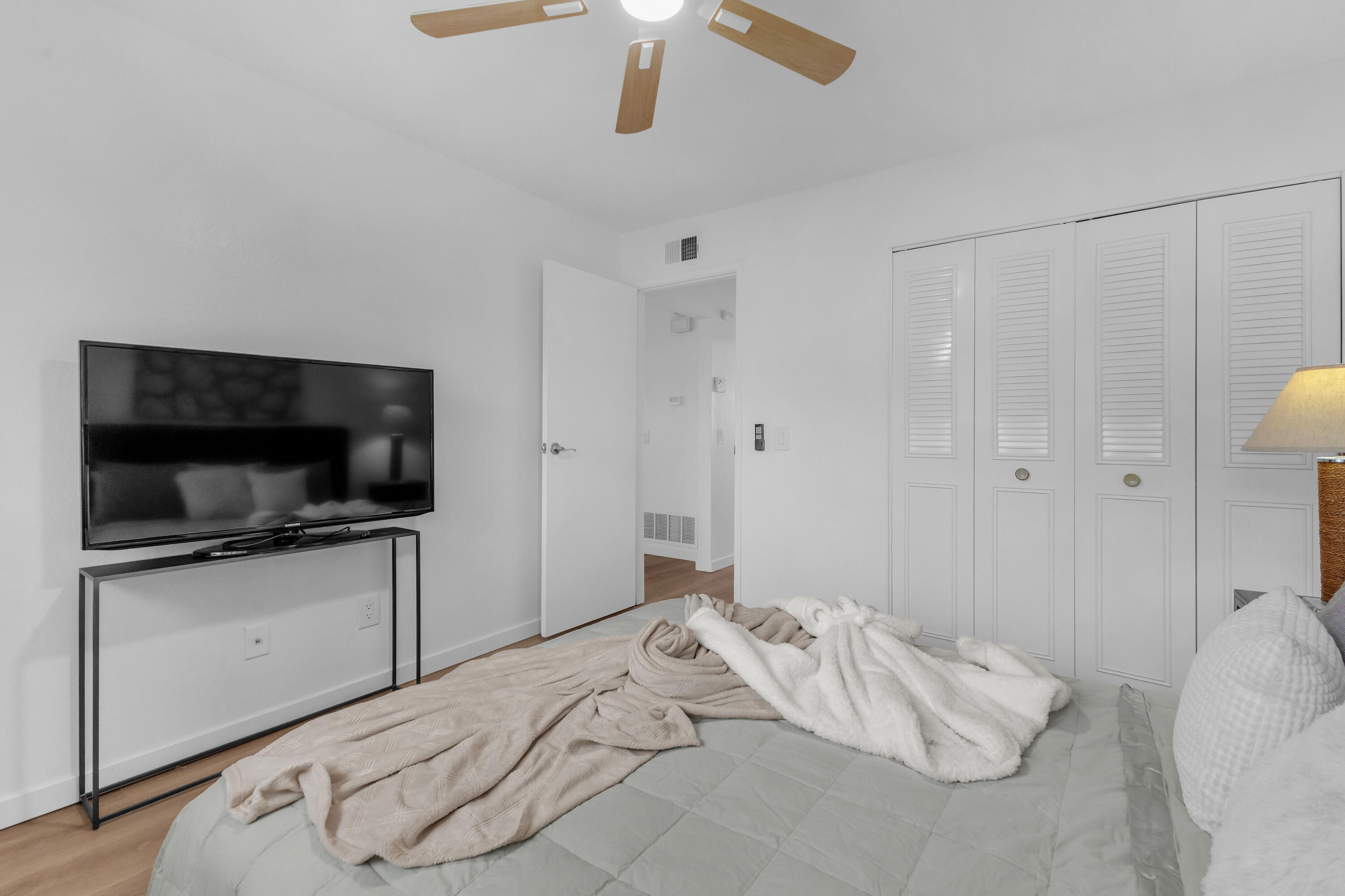 72682 Thrush Road, Unit 1 Palm Desert, CA 92260 - Photo 30 of 40 a bedroom with a bed and a flat screen tv