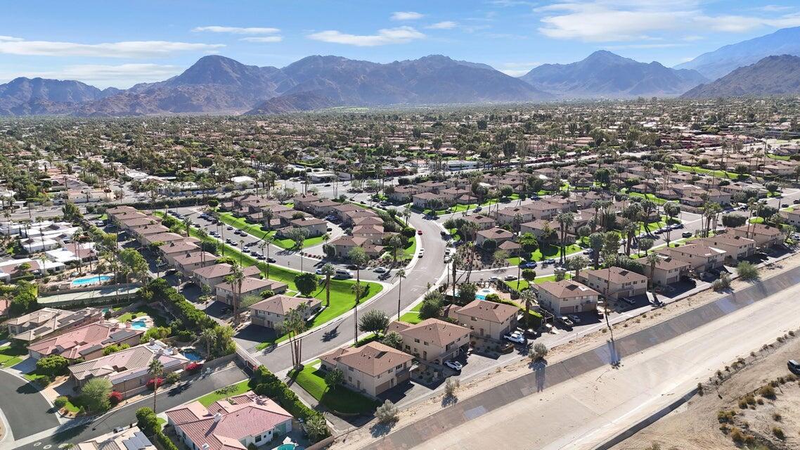 72682 Thrush Road, Unit 1 Palm Desert, CA 92260 - Photo 38 of 40 an aerial view of a city with lots of residential buildings and mountain view in back