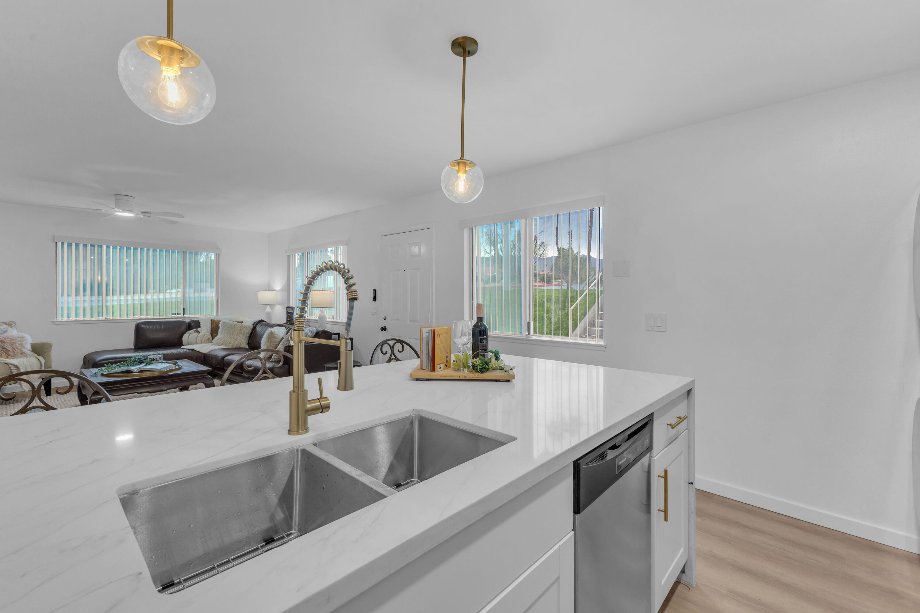 72682 Thrush Road, Unit 1 Palm Desert, CA 92260 - Photo 8 of 40 a kitchen with a sink a counter and chairs