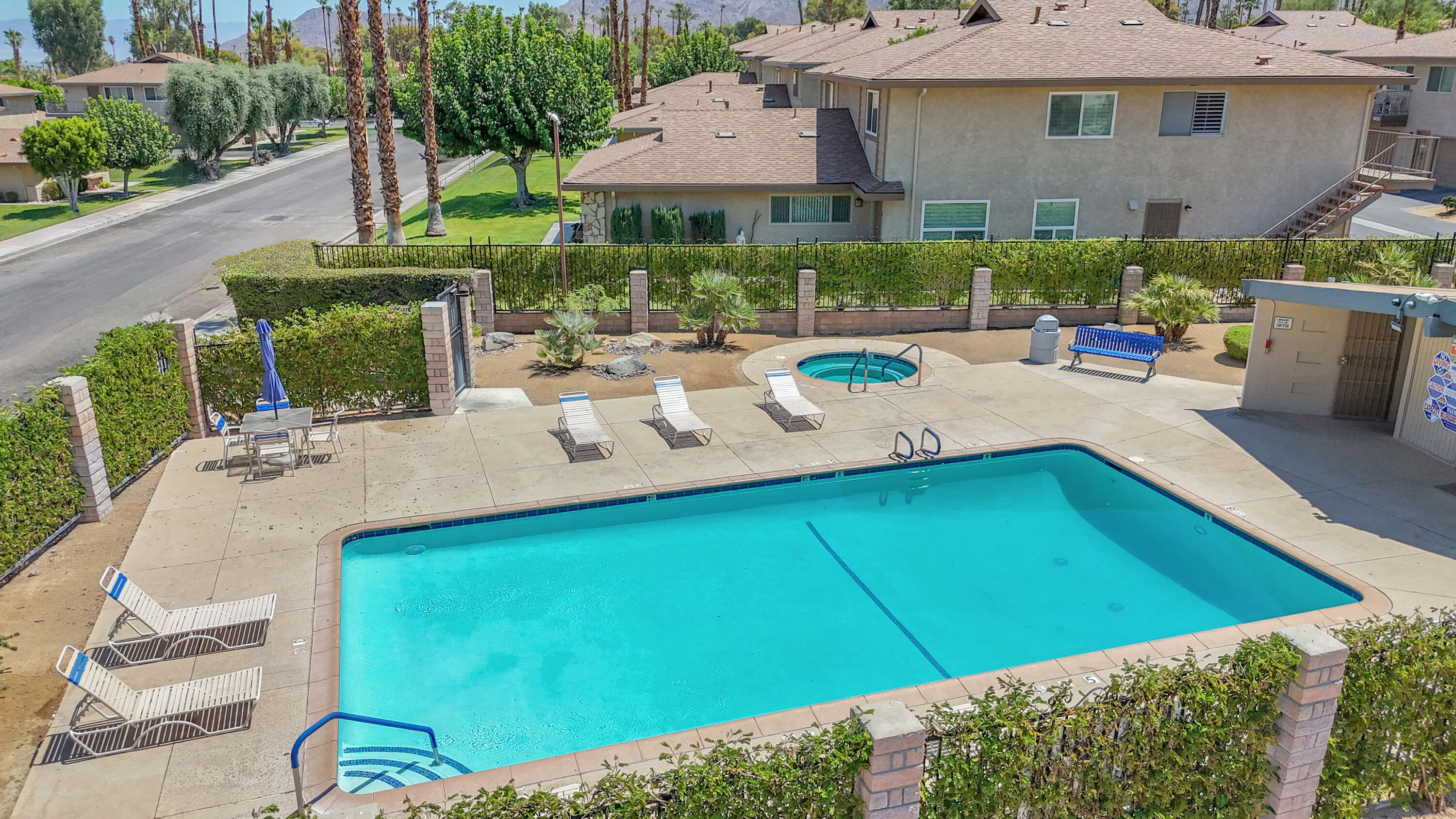 72682 Thrush Road, Unit 1 Palm Desert, CA 92260 - Photo 10 of 40 a view of a patio with table and chairs under an umbrella
