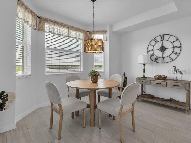 19116 Scallop Loop, Unit 303 Lakewood Ranch, FL 34211 - Photo 12 of 32 a dining room with furniture and window