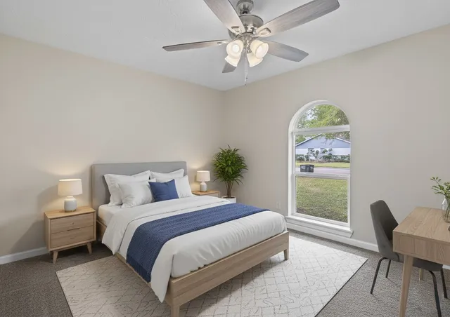 a bedroom with a bed and a chair