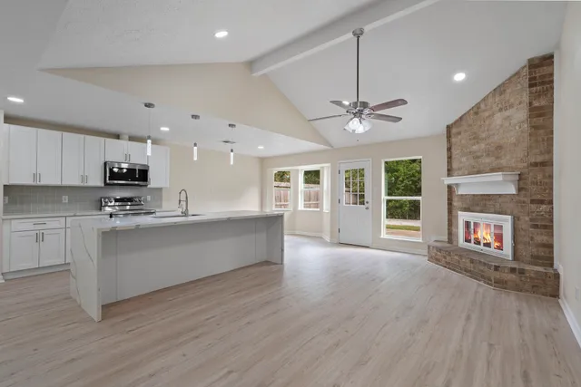 a view of kitchen with sink and microwave