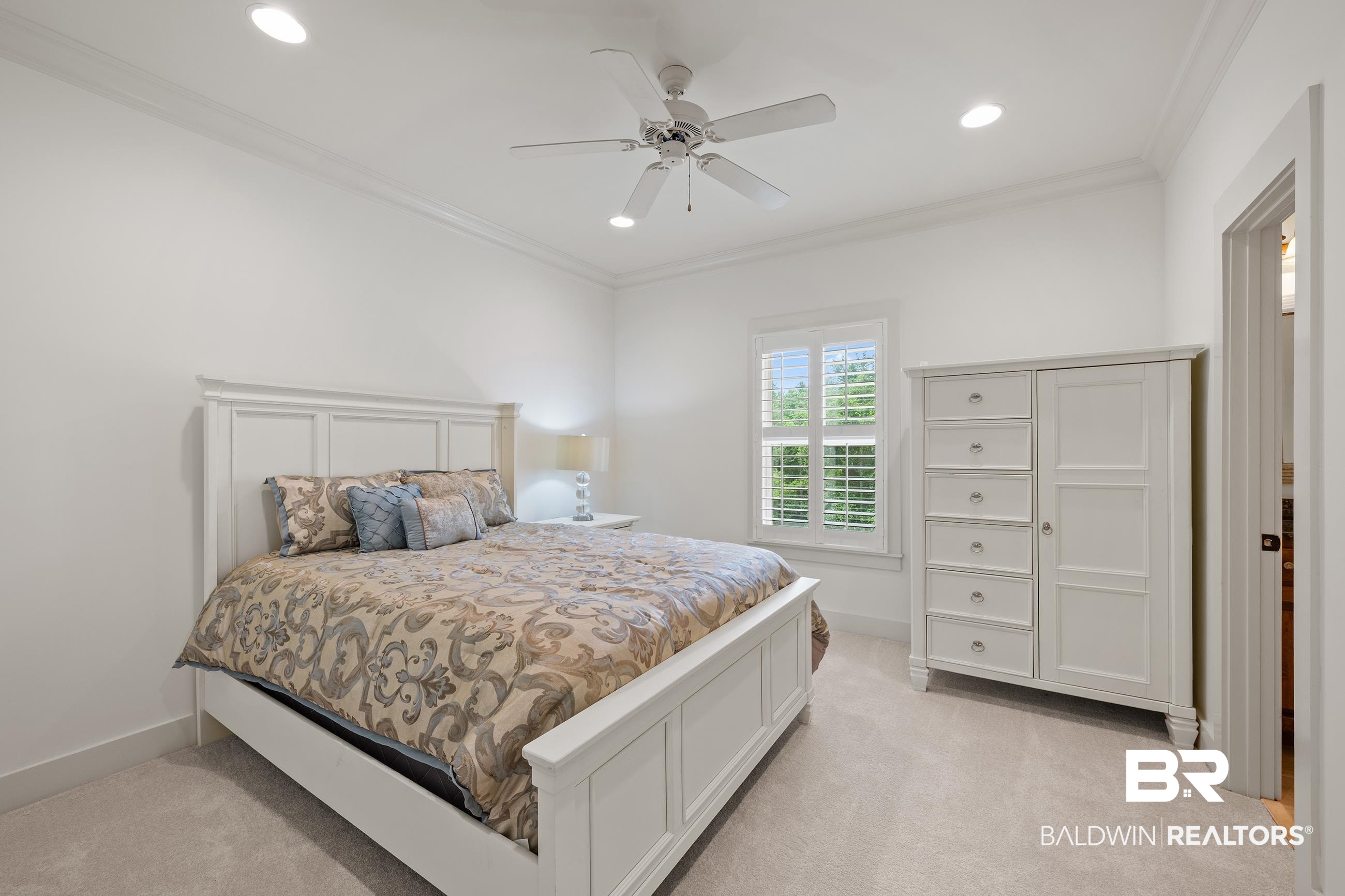 30463 Dolive Ridge Daphne, AL 36527 - Photo 54 of 58 Bright bedroom with plush carpeting, crown molding, a ceiling fan, recessed lighting, and a window featuring plantation shutters