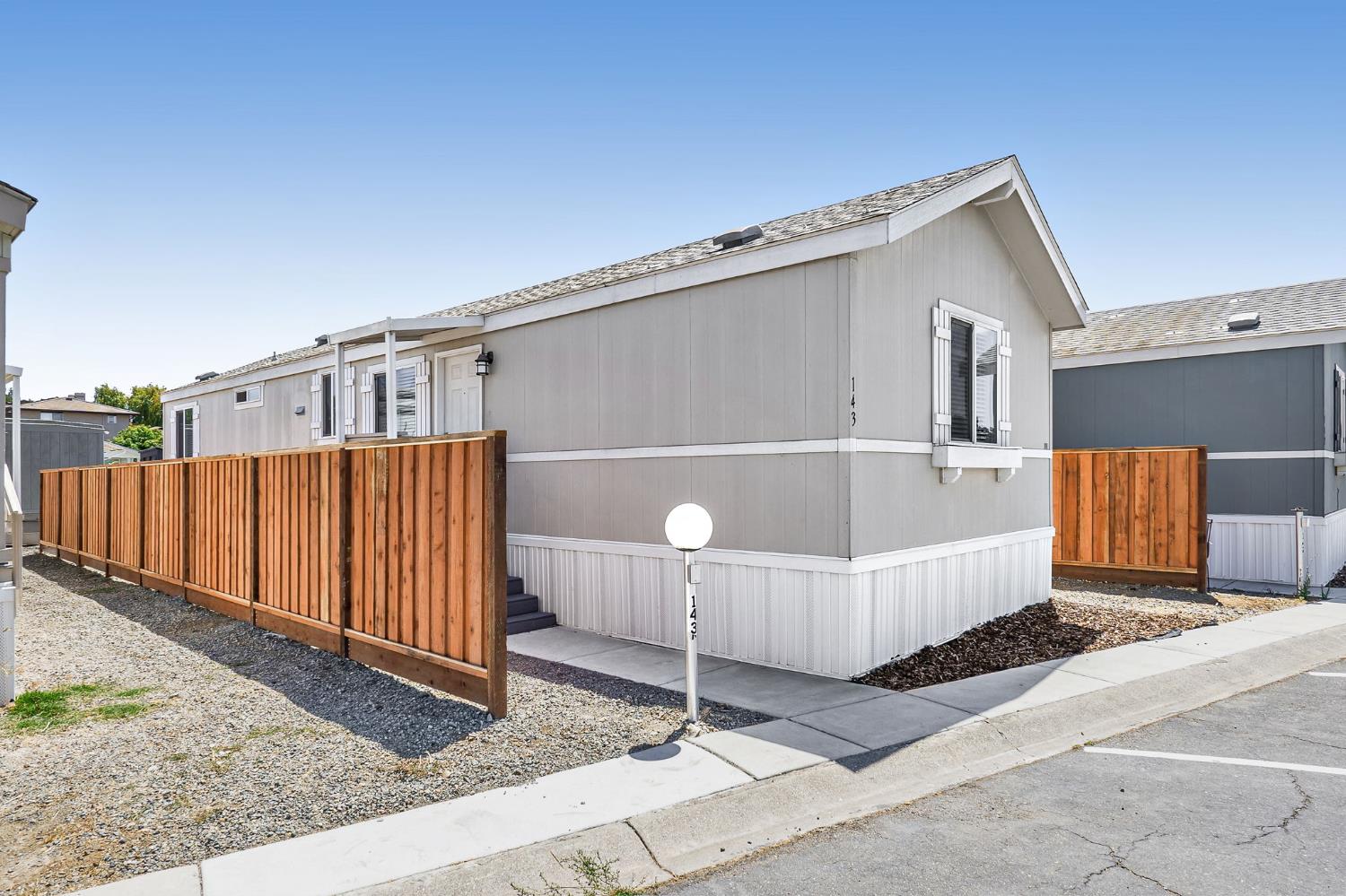 a front view of a house with wooden fence