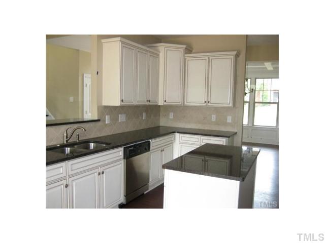 255 Waterville Street Raleigh, NC 27603 - Photo 8 of 25 a kitchen with granite countertop a sink and cabinets