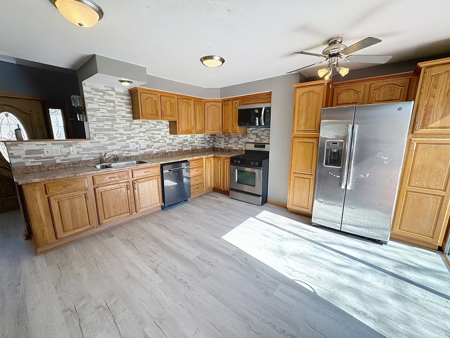 848 20th Avenue Moline, IL 61265 - Photo 7 of 20 a open kitchen with stainless steel appliances granite countertop a stove a sink dishwasher and a refrigerator with wooden floor