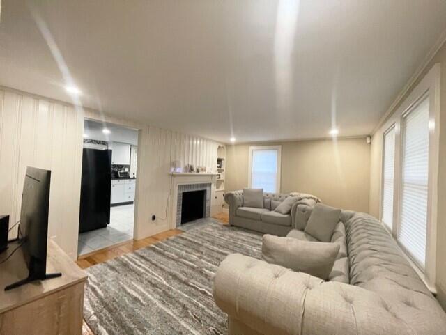 41 Bacon Road Hyannis, MA 02601 - Photo 3 of 22 a living room with furniture a fireplace and a flat screen tv