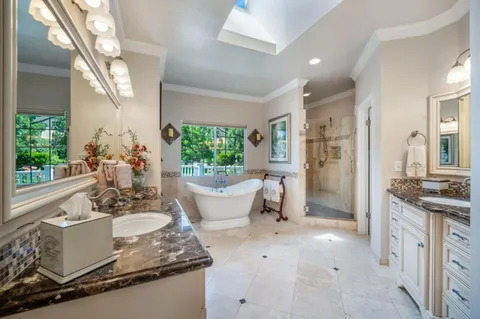 a kitchen with stainless steel appliances kitchen island granite countertop a stove a refrigerator a sink and dishwasher with wooden floor