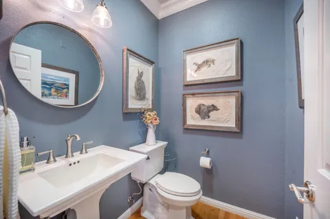 a bathroom with a granite countertop sink a toilet and a mirror
