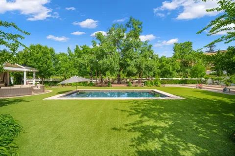 an aerial view of residential house with outdoor space and swimming pool