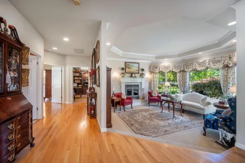a living room with furniture large window and a fireplace