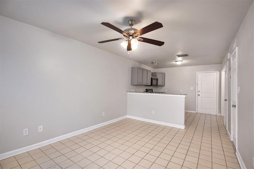 4936 Flamingo Road Fort Worth, TX 76119 - Photo 7 of 24 a view of a kitchen with a sink and a window