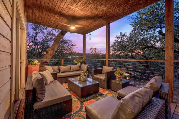 a roof deck with couch and chairs