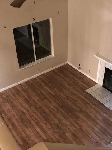 a view of a room with wooden floor and bathroom
