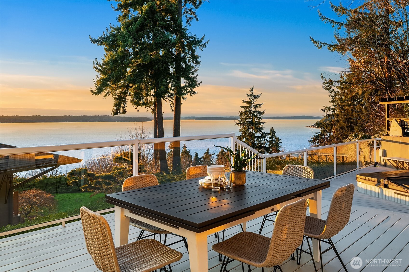 13621 18th Avenue Southwest Burien, WA 98166 - Photo 16 of 40 a view of a balcony with table and chairs and wooden floor