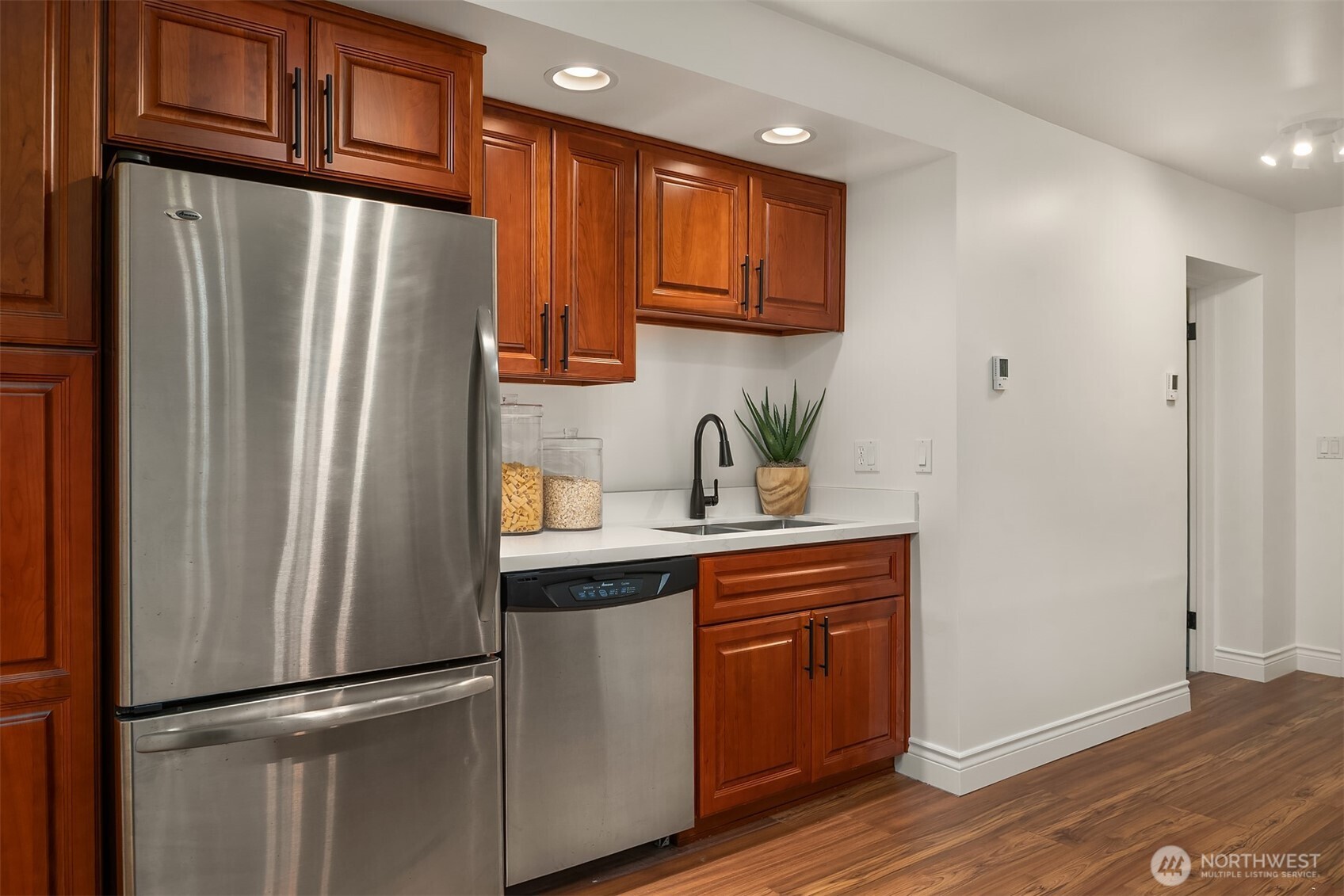 13621 18th Avenue Southwest Burien, WA 98166 - Photo 27 of 40 a kitchen with stainless steel appliances granite countertop a refrigerator and a sink
