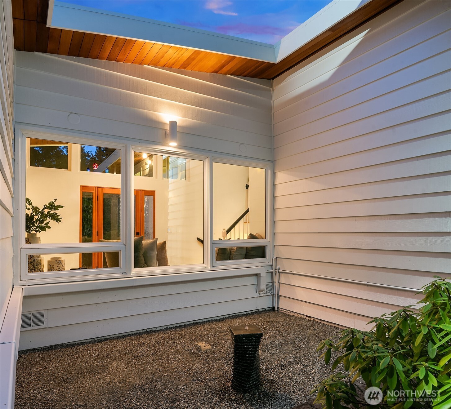 13621 18th Avenue Southwest Burien, WA 98166 - Photo 36 of 40 a porch with a bench next to a yard