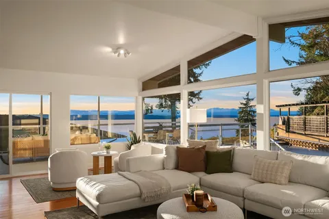 a living room with furniture and a floor to ceiling window