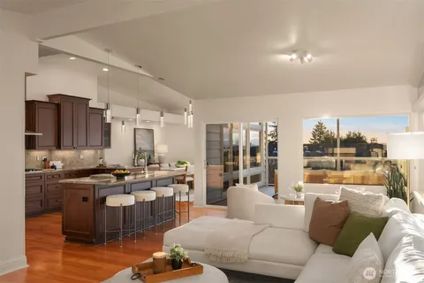 a living room with lots of furniture and kitchen view