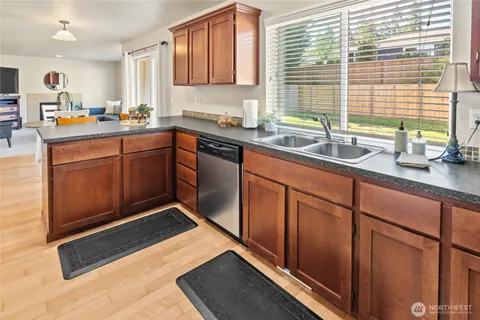 a kitchen with stainless steel appliances granite countertop a sink stove and cabinets