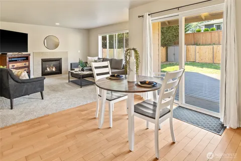 a living room with fireplace furniture and a large window