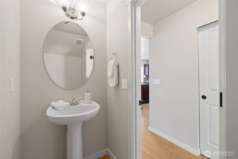 a bathroom with a sink a mirror and a vanity