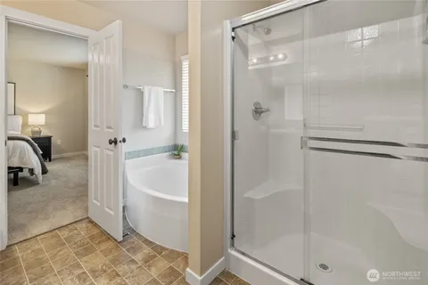 a bathroom with a bathtub and a shower