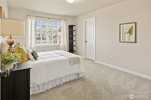 a spacious bedroom with a bed and a window